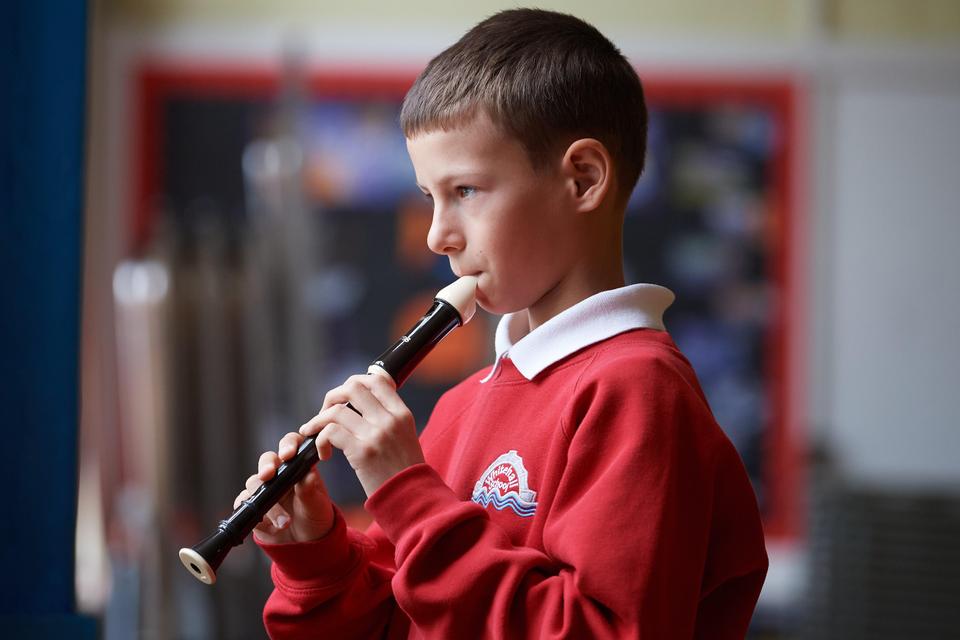 Pupil playing the recorder