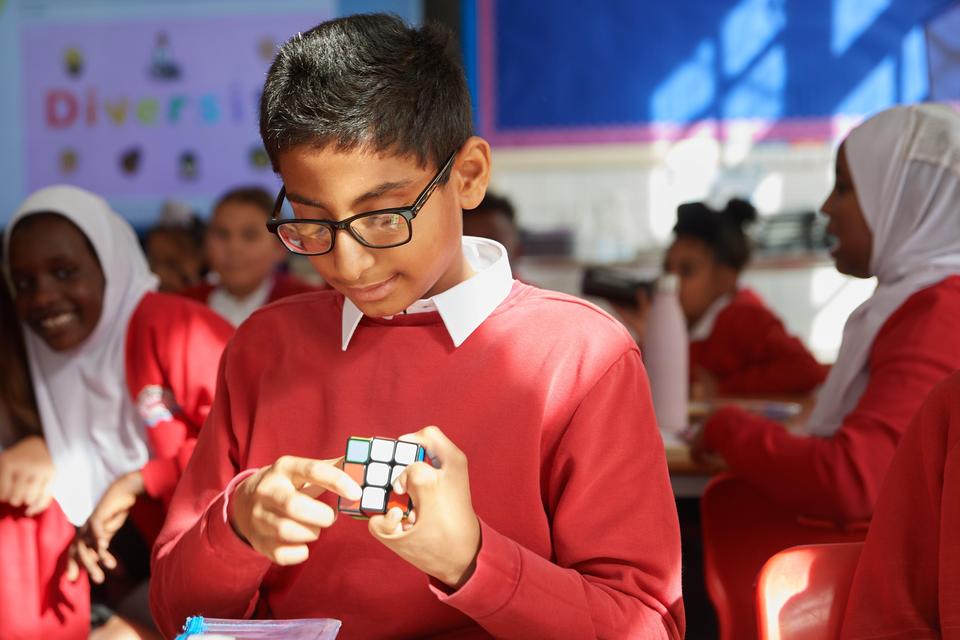 Pupil solving a Rubik's cube puzzle