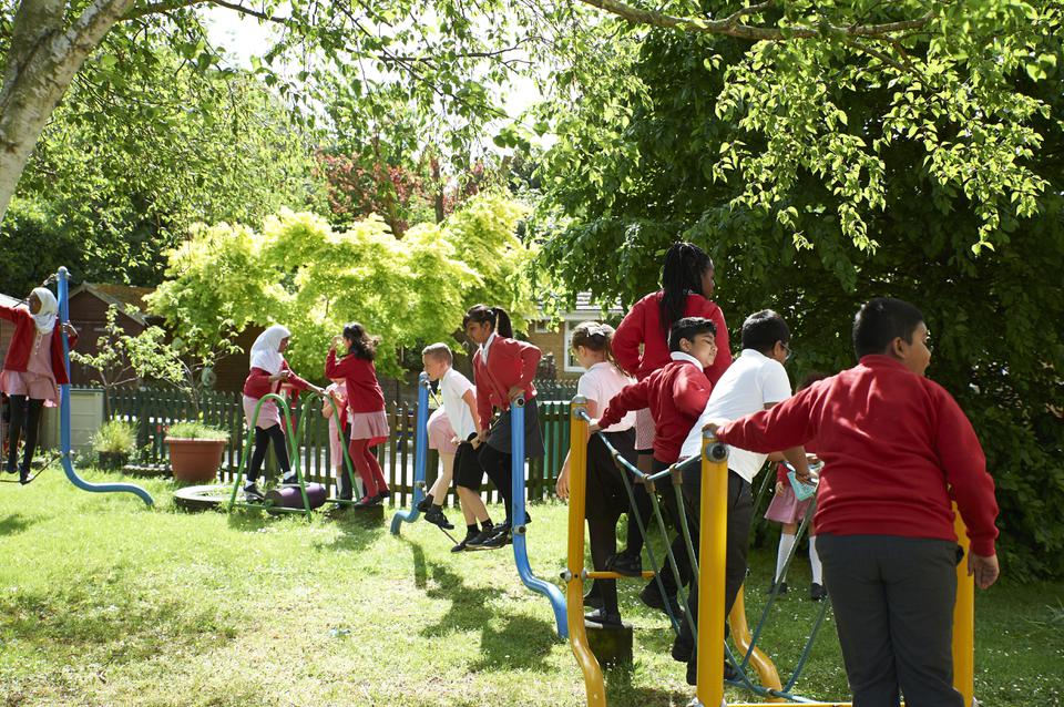 Children playing on The Grove play equipment