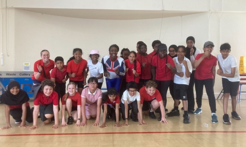 Lesley Owusu pictured with pupils